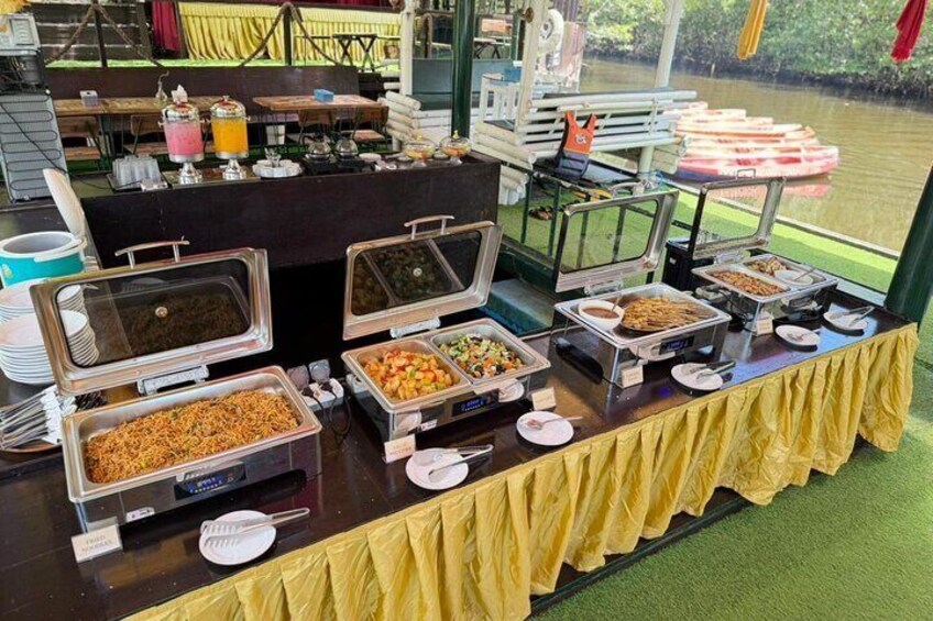 A buffet table with various food items and beverages. 3