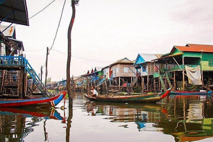 A waterway with traditional boats and wooden houses. 5