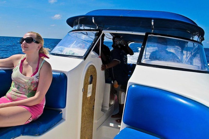 A boat with blue seats and a person in a pink swimsuit. 3