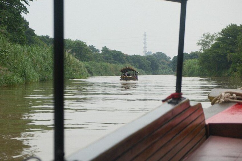 A river with a boat and a houseboat in the distance. 5