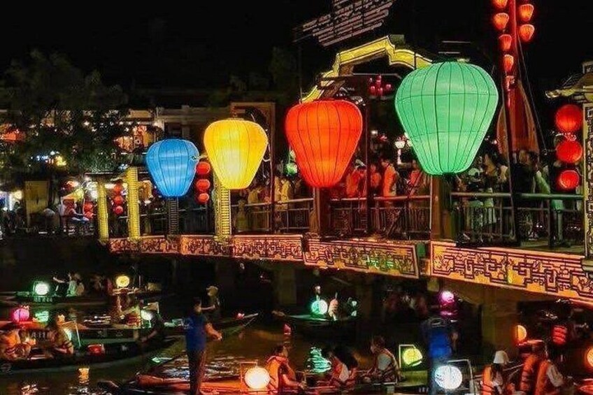 A night scene with a bridge decorated with colorful lanterns and traditional architecture. 2