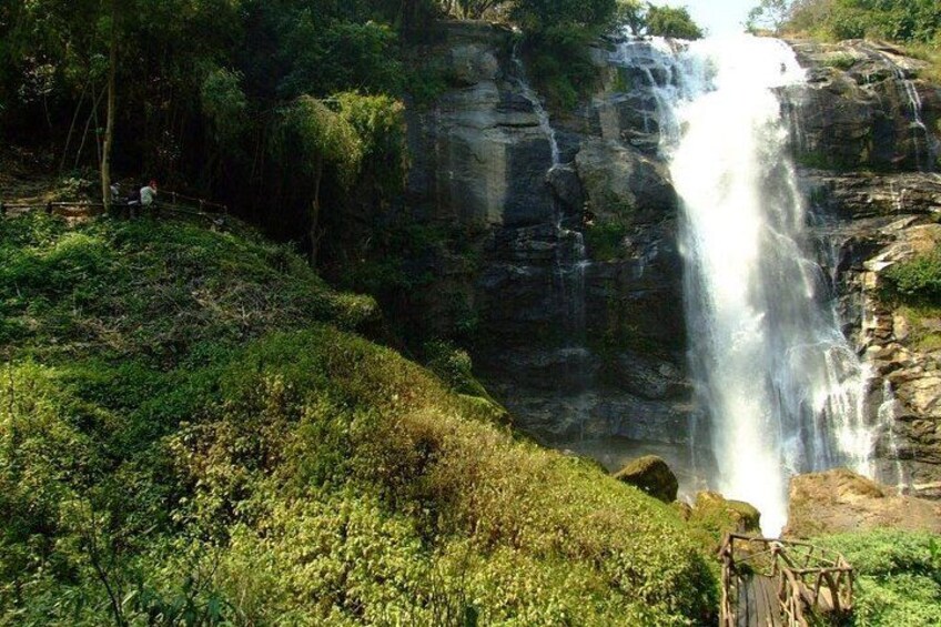 A waterfall cascading down a rocky cliff surrounded by lush greenery. 5