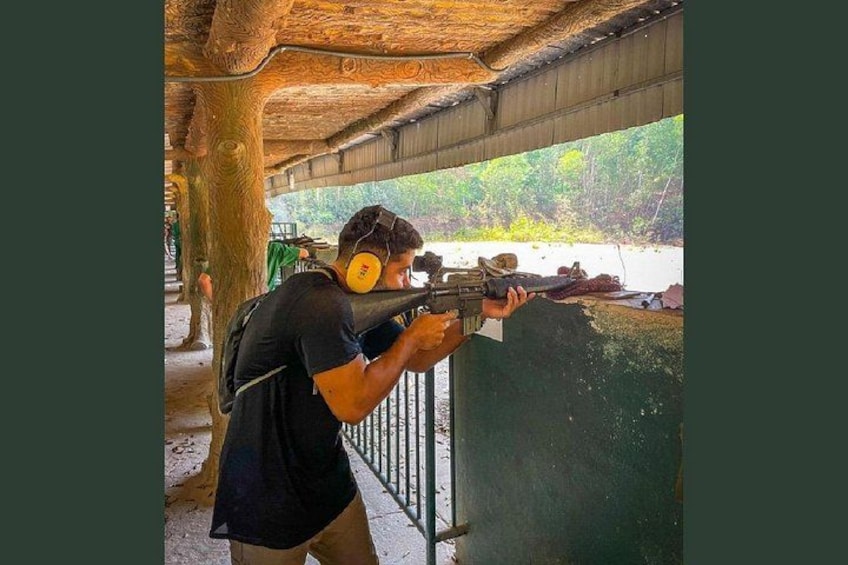 A person aiming a rifle at a target. 4
