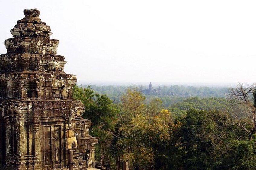 An ancient stone temple surrounded by dense forest. 5