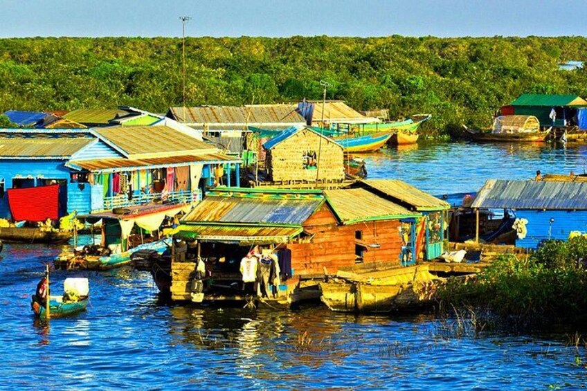 Floating houses on a river, surrounded by lush greenery. 3