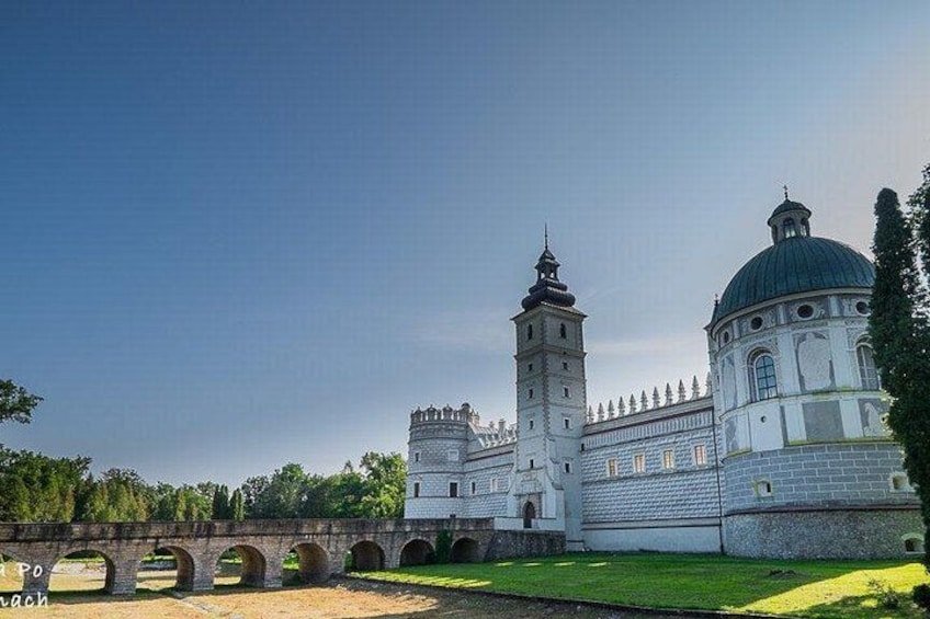 A large white building with a green dome and a tall tower. 5