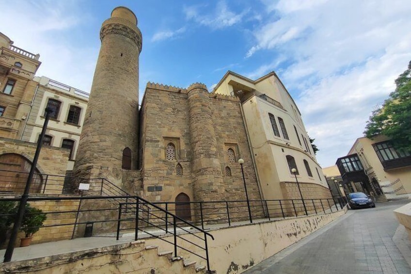 A historic building with a prominent tower and arched windows. 3
