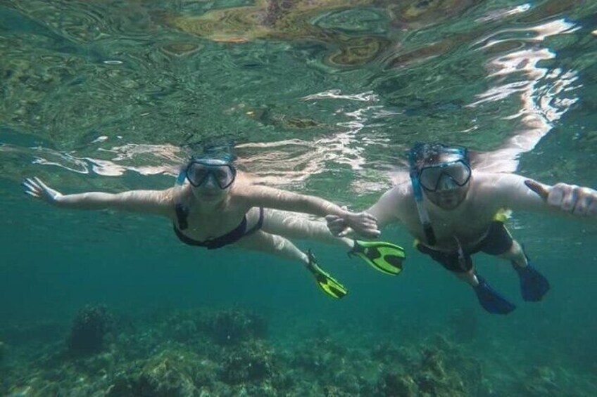 Two people snorkeling underwater. 2