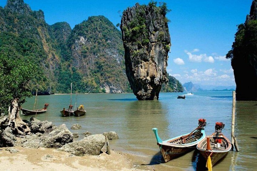 A calm river with boats, rocky cliffs, and lush greenery. 5