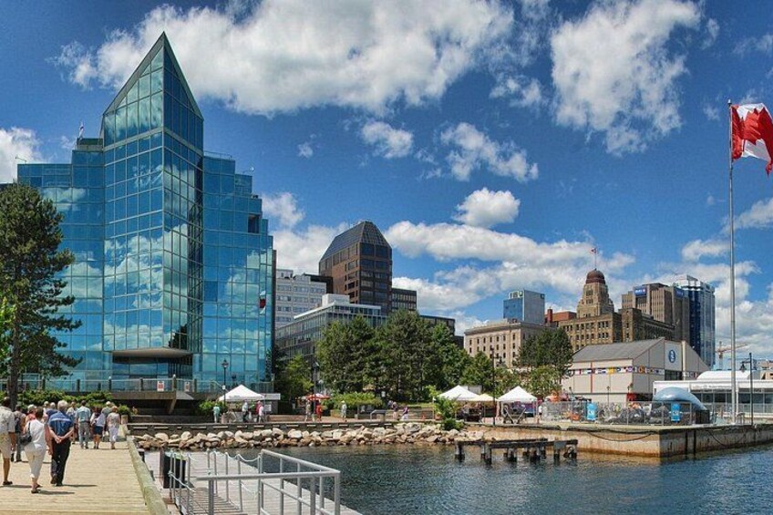A waterfront cityscape with modern buildings, a dock, and a flag. 1