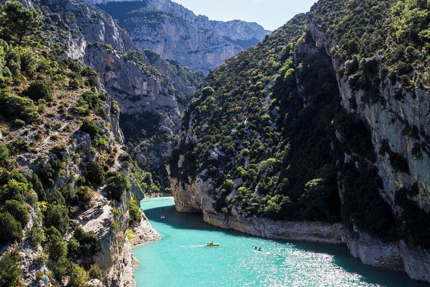 A turquoise river winding through a rocky gorge with cliffs on either side. 4