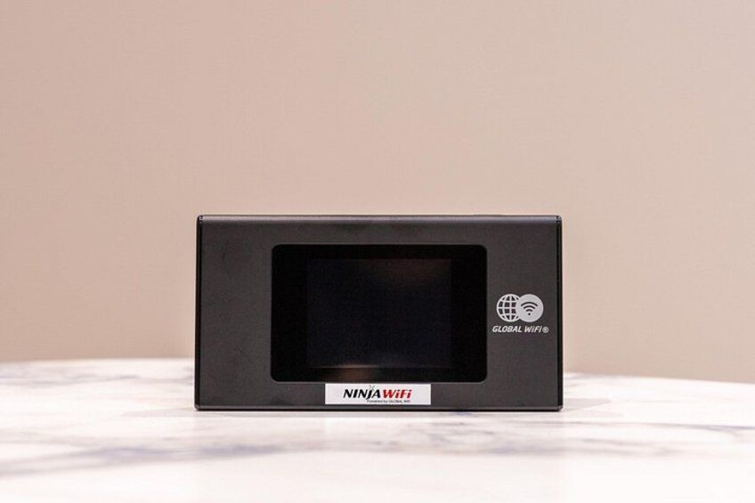 A black NINJA WiFi router on a white surface. 2