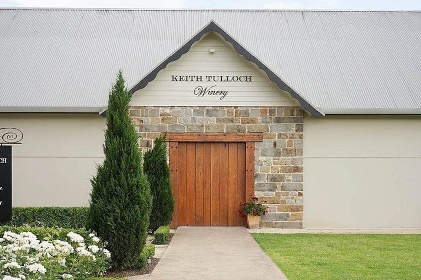 A building with a stone facade and a wooden door, labeled 'Keith Tulloch Winery.' 4
