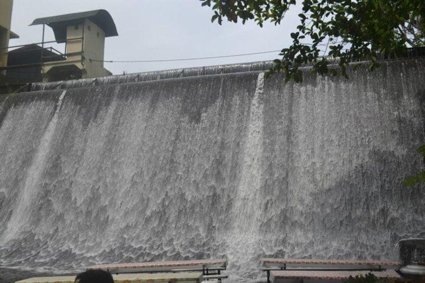 A large waterfall cascading down a concrete wall. 4
