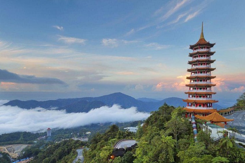 A pagoda with multiple tiers, surrounded by lush greenery and mountains in the background. 3