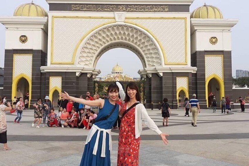 A large archway with intricate patterns and a golden dome in the background. 4