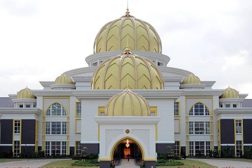 A large building with multiple golden domes and white walls. 4