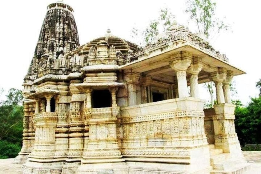 An ancient stone temple with intricate carvings and a large spire. 2