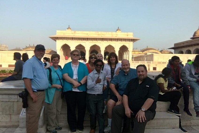 A group of people posing in front of a historical building with arches and domes. 5