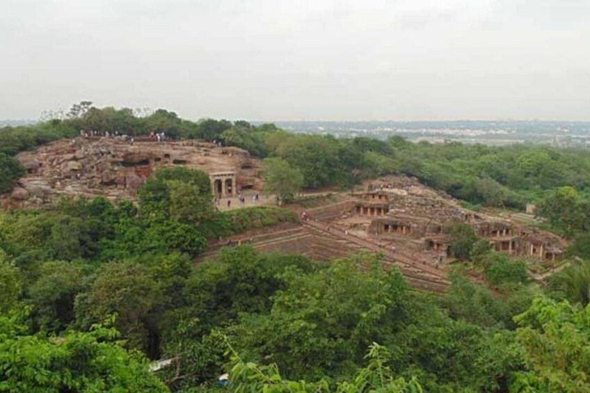 An ancient archaeological site with ruins and dense forest. 3