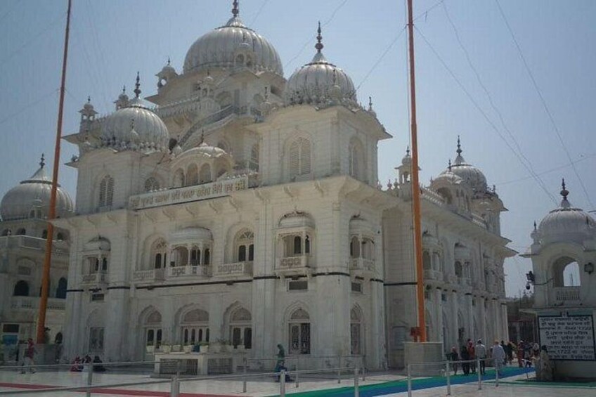 A large white building with multiple domes and arched windows. 5