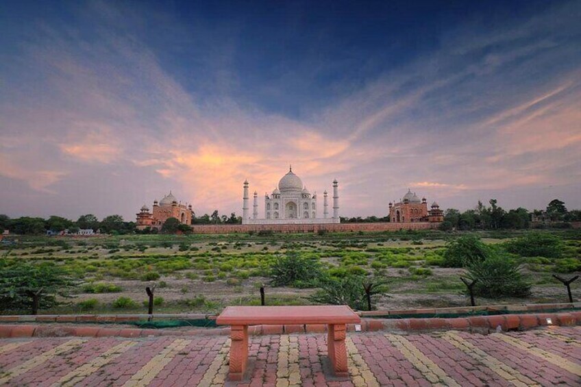 The Taj Mahal with a bench in the foreground. 1