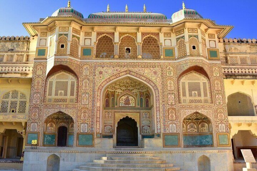 A historic building with intricate architectural details, including arched doorways and decorative patterns. 4