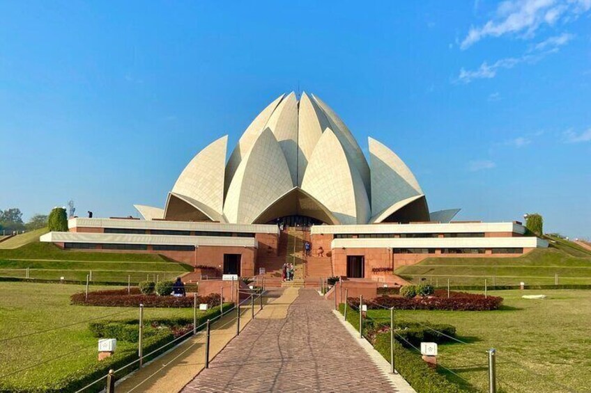 A large, white lotus-shaped building with a central dome and a long, straight entrance. 2