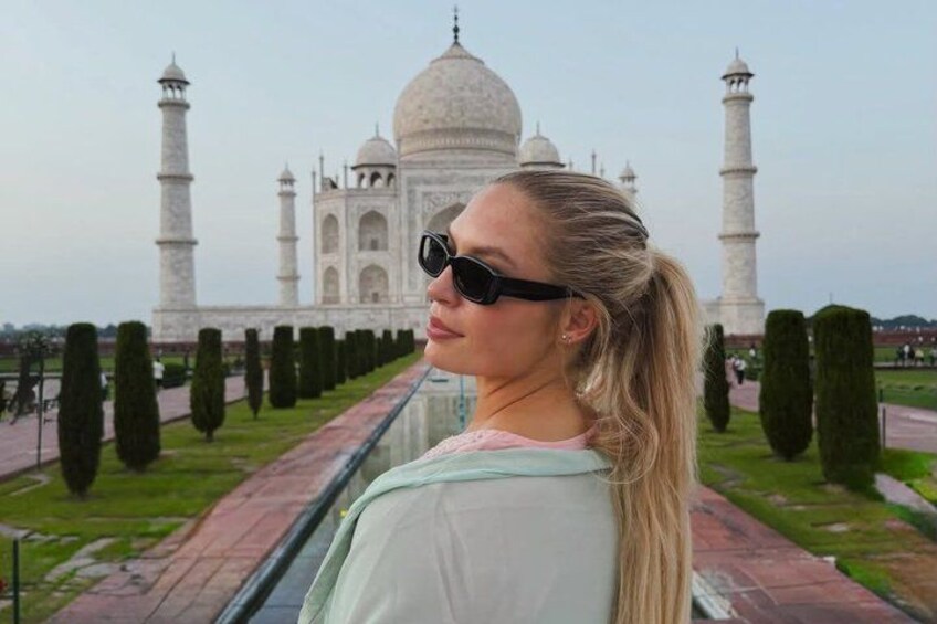 A person standing in front of the Taj Mahal. 1
