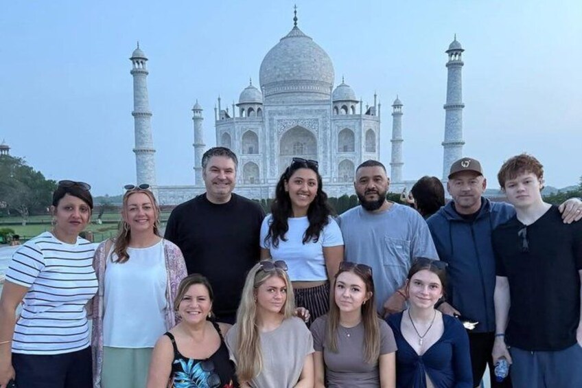 A group of people standing in front of the Taj Mahal. 2