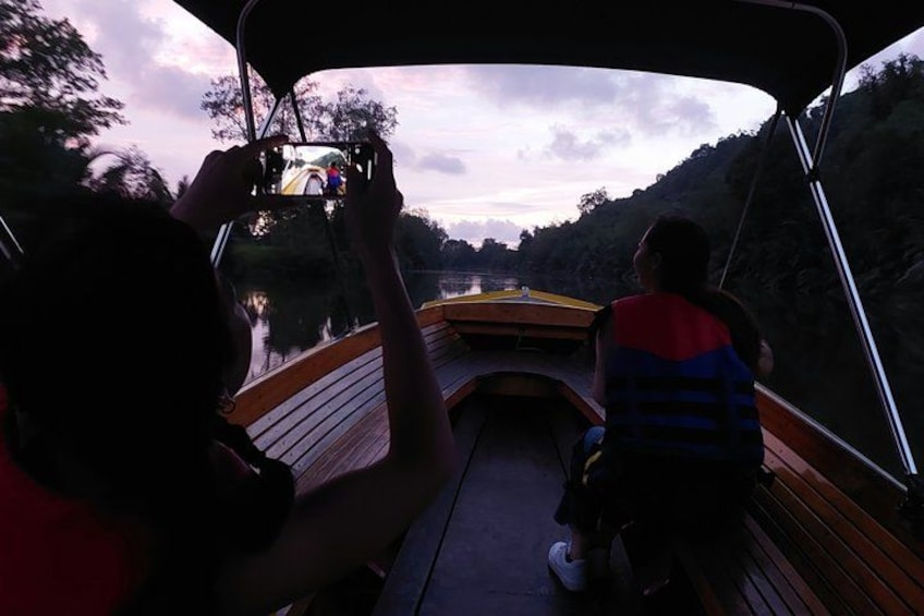 A person taking a photo of a bridge from a boat. 4