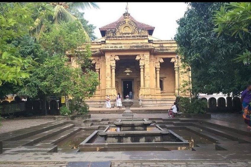 A temple with a central water feature, surrounded by lush greenery. 2