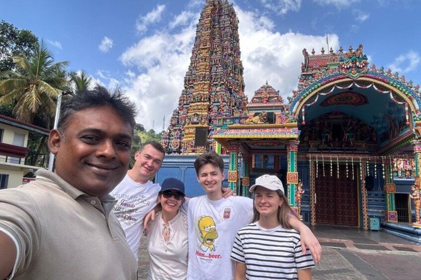 A temple with intricate architecture and a group of people in front. 2