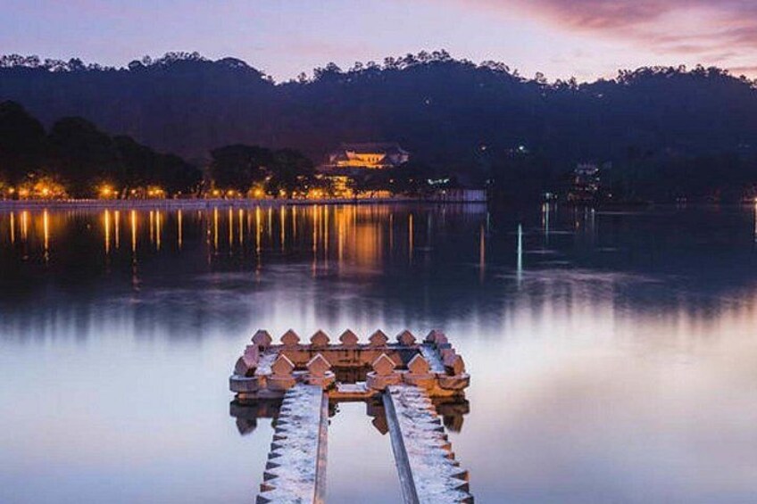 A calm lake with a wooden dock and a traditional building in the background. 3