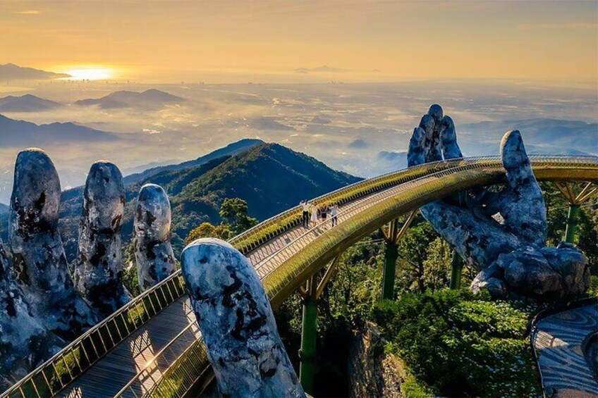 A bridge with a unique design, surrounded by large rock formations and a mountainous landscape. 1