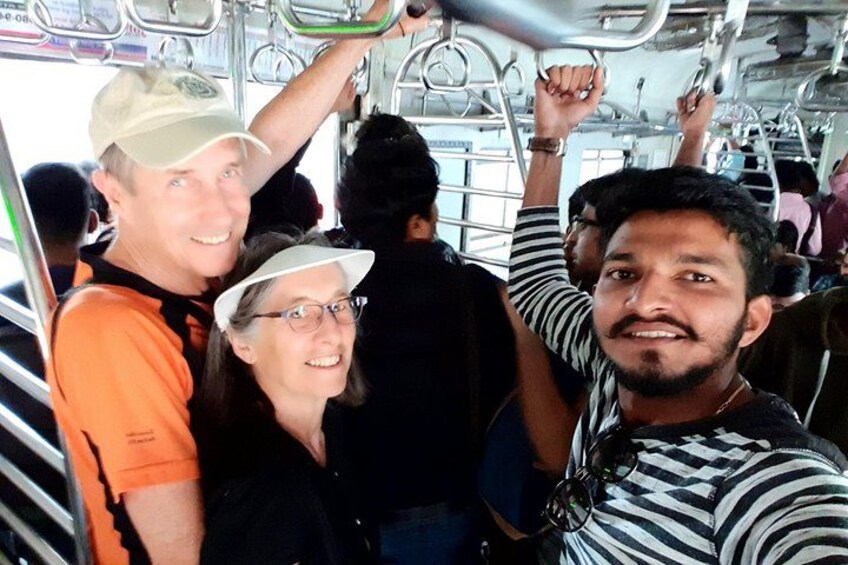 A crowded bus interior with metal handrails and seats. 3