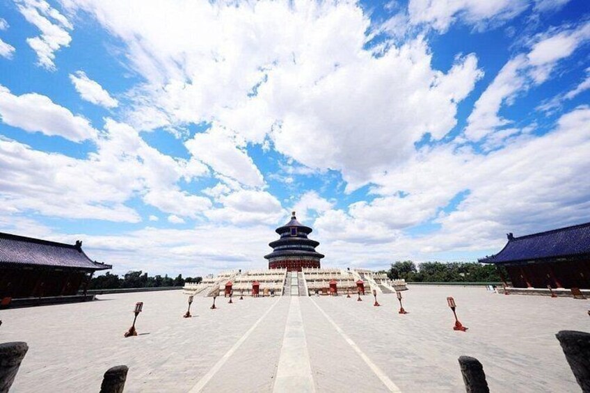 A traditional Chinese pagoda with a clear sky and a paved pathway leading to it. 5
