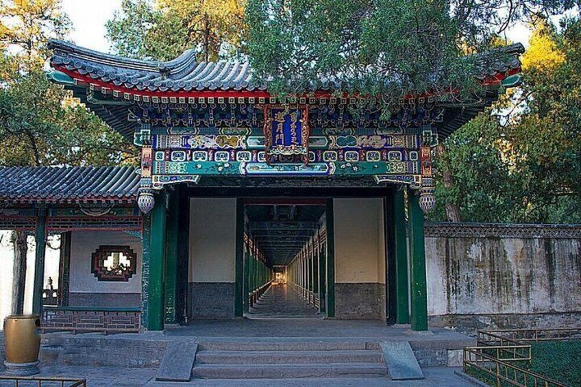 A traditional Chinese gate with intricate designs and a staircase leading into a courtyard. 2