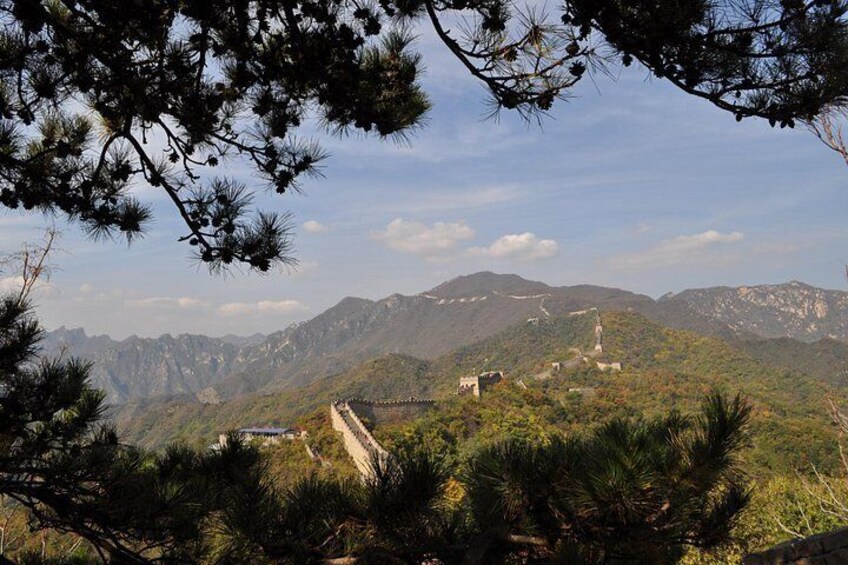 A mountainous landscape with a prominent road, a bridge, and a tower. 1