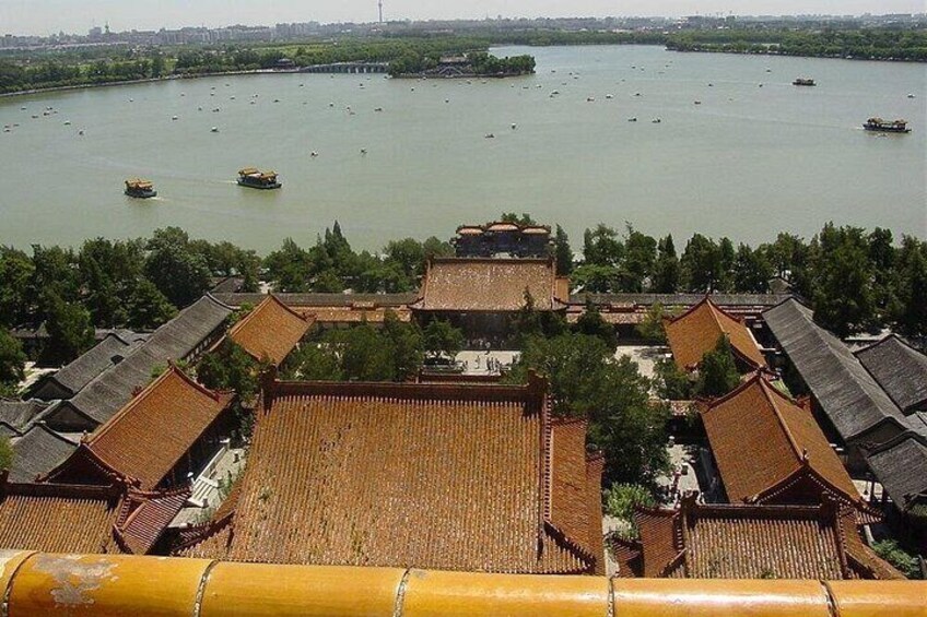 A traditional Chinese courtyard with tiled roofs, surrounded by a river with boats. 3