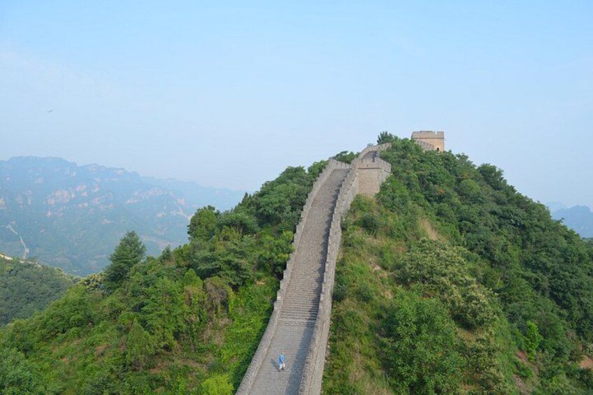 A long, winding mountain road with a person walking. 4