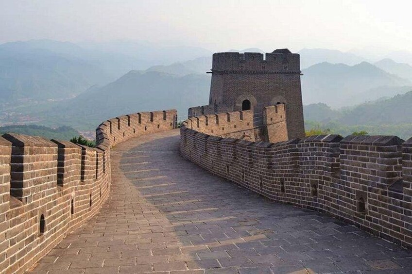 The Great Wall of China, a historical fortification, with a watchtower and a mountainous backdrop. 3