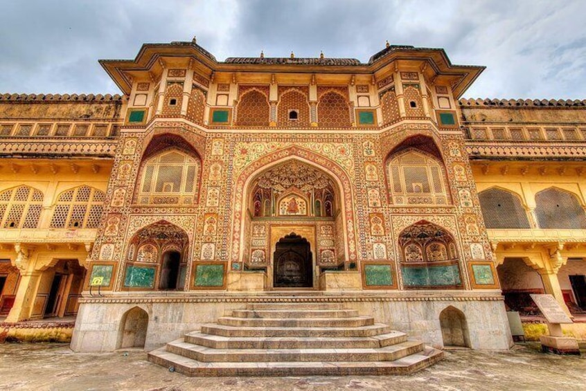 A grand building with intricate architectural details, including arched doorways and decorative patterns. 5