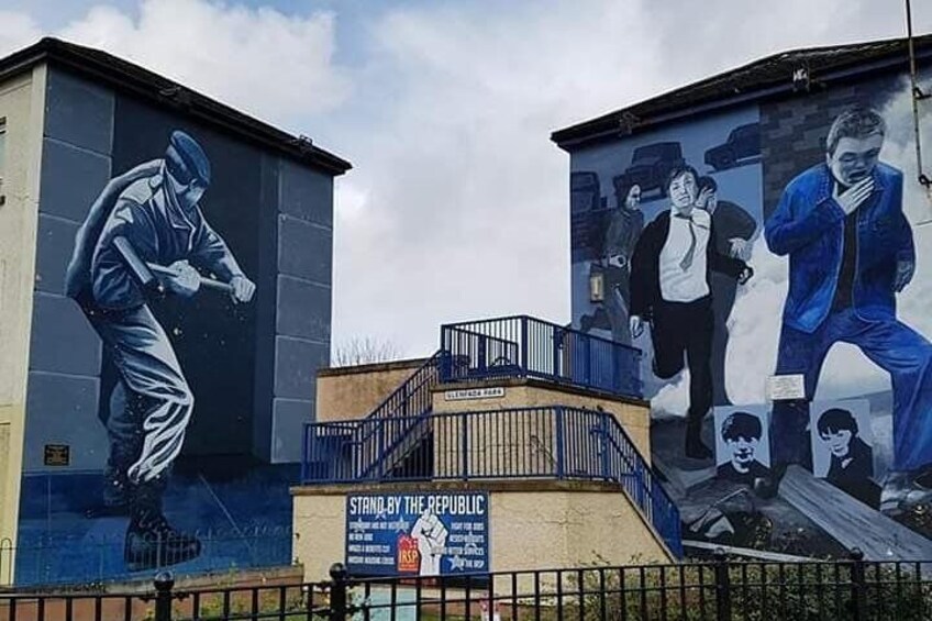 A mural on a building with a staircase leading up to it. 4