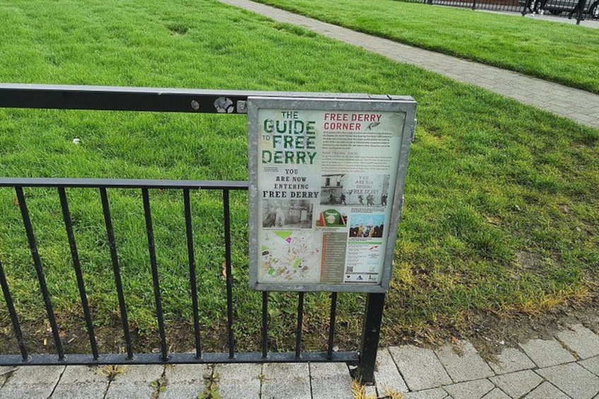 A signboard titled 'THE GUIDE TO FREE DERRY' with a map and information. 5