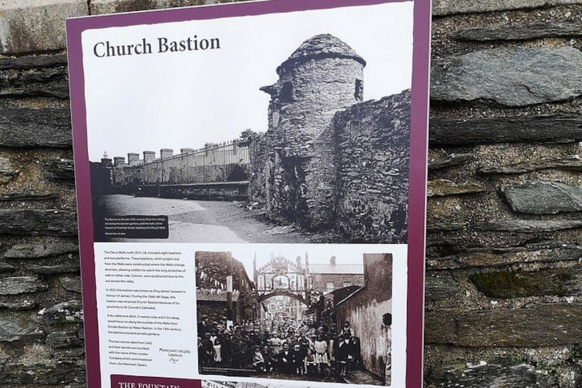 A historical church with a stone tower and a stone wall. 4