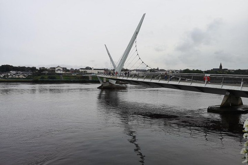 A cable-stayed bridge over a river with a town in the background. 2