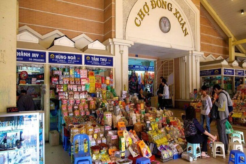 A market with various stalls selling snacks and drinks. 2