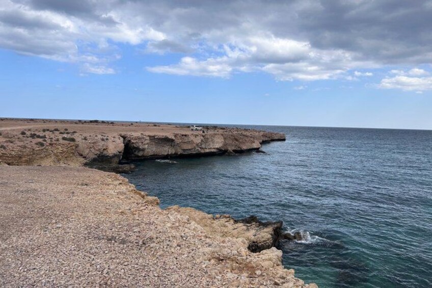 A rocky coastline with a clear sky. 4