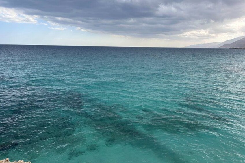 A turquoise sea with a cloudy sky. 3
